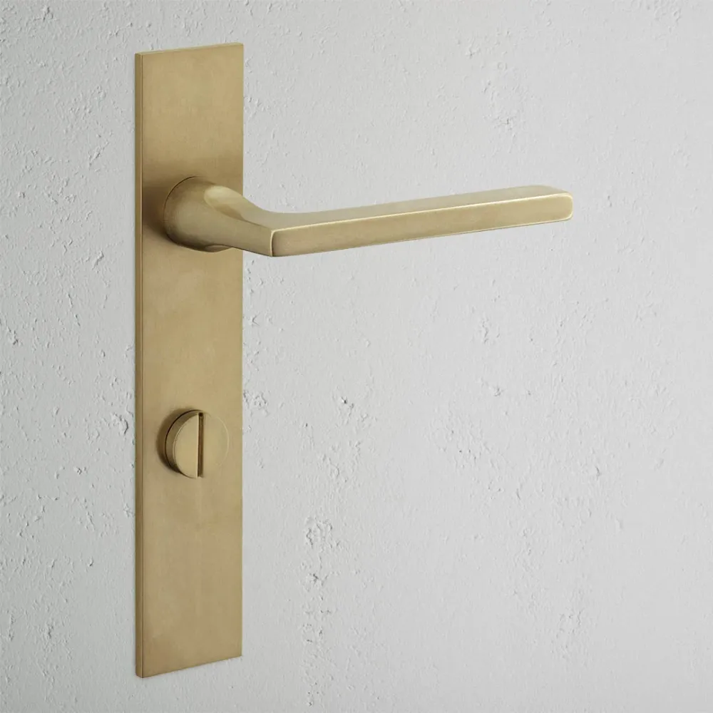 Manilla para puertas Clayton con placa larga (con muelle) y sistema giratorio - Latón antiguo