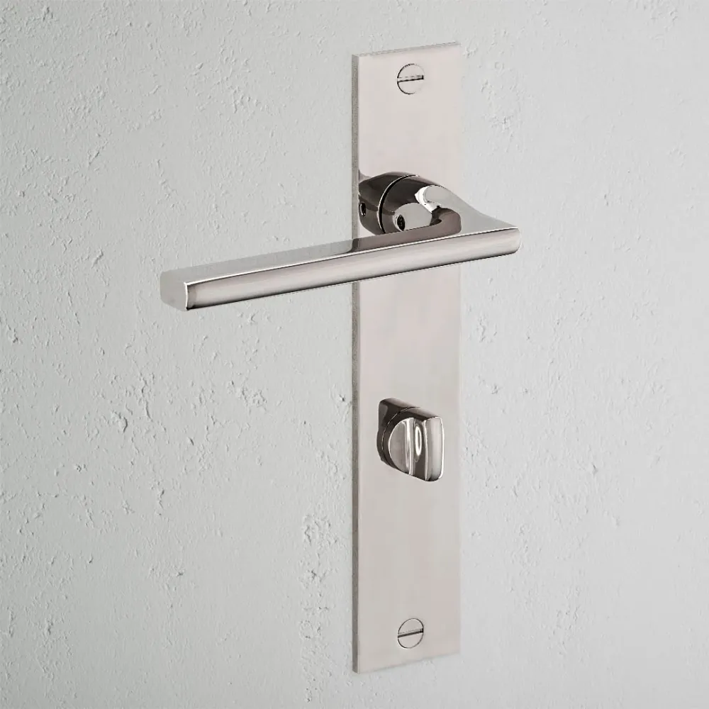 Manilla para puertas Clayton con placa larga (con muelle) y sistema giratorio - Níquel pulido