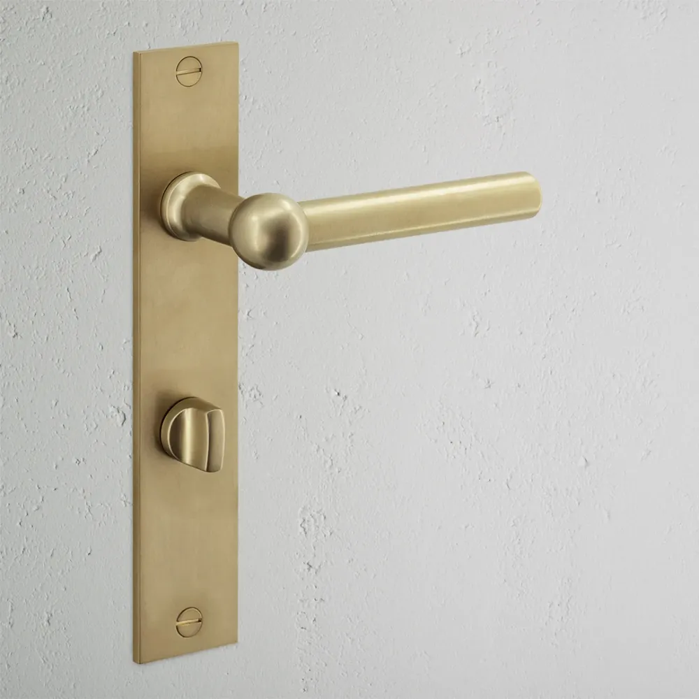 Manilla para puertas Harper con placa larga (con muelle) y condena - Latón antiguo