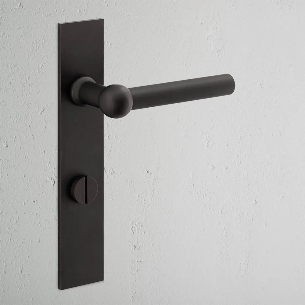 Manilla para puertas Harper con placa larga (con muelle) y sistema giratorio - Bronce