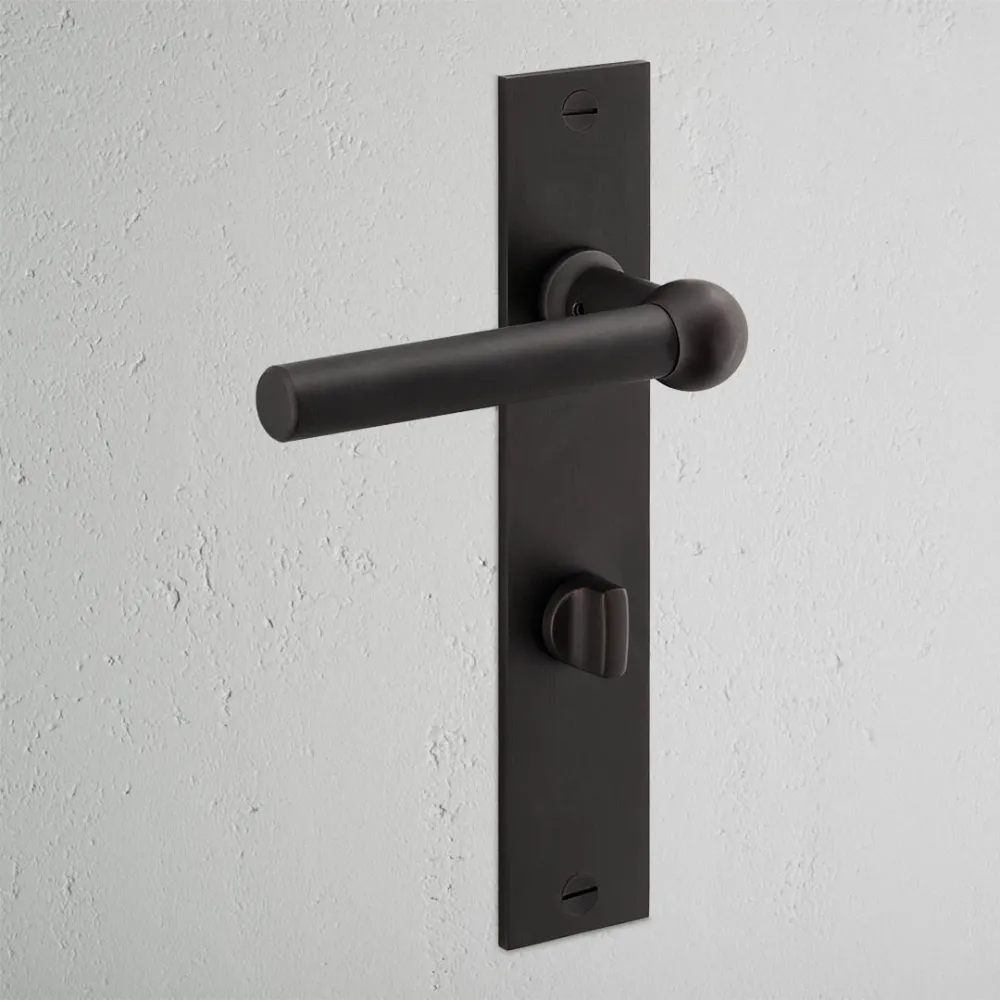 Manilla para puertas Harper con placa larga (con muelle) y sistema giratorio - Bronce